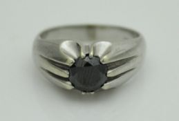 A 9 carat white gold black diamond solitaire ring, the stone approx 1.