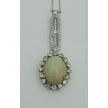 A yellow and white gold pendant set with large central opal surrounded by sixteen brilliant cut