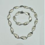 A Scandinavian-style silver necklace and matching bracelet as stylised leaves,