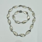 A Scandinavian-style silver necklace and matching bracelet as stylised leaves,