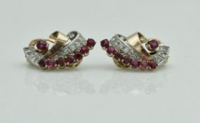 A pair of 18 carat gold mounted ruby and diamond set clip-on earrings in a scroll form, 8.7 g, 2.