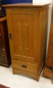 A modern oak cupboard with single door above fitted drawer by L & J G Stickley Inc bears metal