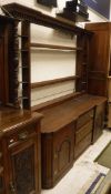 A 19th Century oak dresser with plate rack over three drawers and two cupboard doors