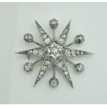 A circa 1900 white gold, silver and diamond set brooch of star burst form,