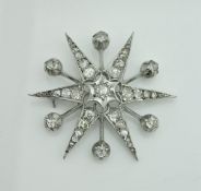 A circa 1900 white gold, silver and diamond set brooch of star burst form,