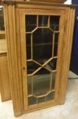 A pine single glazed door cabinet