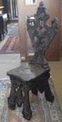 A 19th Century Continental (probably Tyrolean) carved walnut hall chair