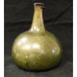 A late 17th Century green glass onion shaped wine bottle
