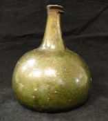 A late 17th Century green glass onion shaped wine bottle