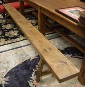 A pair of 19th Century oak bench seats the single piece tops on end trestle supports