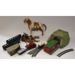 A circa 1900 pony hide covered toy horse on wheels together with various miniature leather tack and