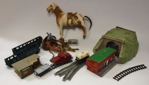 A circa 1900 pony hide covered toy horse on wheels together with various miniature leather tack and