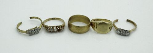 A collection of four various 18 carat gold rings, comprising wedding band,