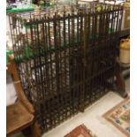 A vintage wrought iron wine cage, the two slatted doors enclosing 144 bottle rack,