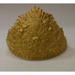 A 19th Century gilt metal 17th Lancers cap badge with embossed Royal cypher,