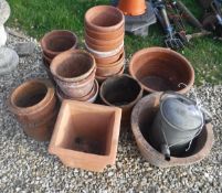 A collection of assorted terracotta pots,
