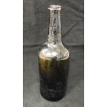 An 18th Century dark green/black glass wine bottle,