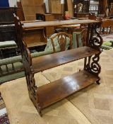 A circa 1900 mahogany three tier waterfall shelf unit on fretwork carved supports