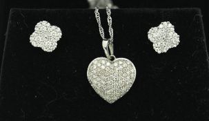 A diamond studded 9 carat white gold heart shaped pendant on chain,