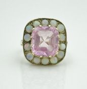 A 9 carat gold dress ring set with large square kunzite stone to centre, surrounded by opal,