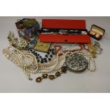 A box containing a collection of various costume jewellery,