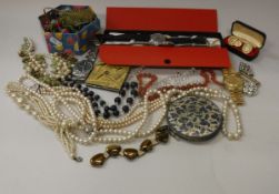 A box containing a collection of various costume jewellery,