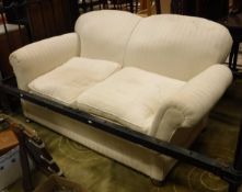 A Victorian drop-end two seater sofa with bun feet