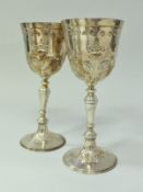 A pair of modern silver goblets with gilt-washed interiors and embossed floral decoration,