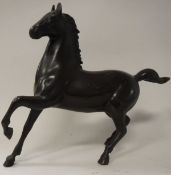 A Chinese chocolate patinated iron figure of a horse