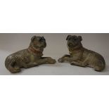 A pair of Austrian painted terracotta figures of recumbant pugs