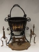 A copper and wrought iron mounted coal bucket in the arts and crafts manner together with a pair of