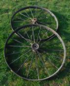 Two wrought iron cartwheel inners and a small cast iron fire back