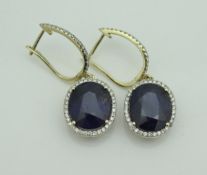 A pair of 14 carat gold sapphire and diamond earrings,