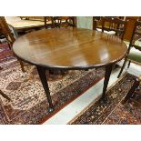 A 19th Century mahogany oval drop-leaf dining table on turned legs to pad feet