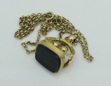 A George V 9 carat gold seal of plain rectangular hardstone form set on a 9 carat gold chain