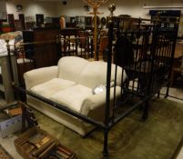 A pair of Victorian wrought iron and brass single bedsteads