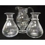 A pair of William Yeoward facet cut glass carafes and matching water jug