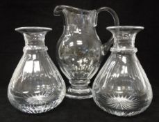 A pair of William Yeoward facet cut glass carafes and matching water jug