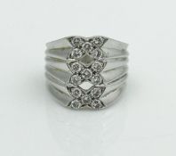 An unmarked 18 carat white gold ring of ribbed form,
