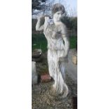 An early 20th Century carved marble figure of a classically robed maiden with cap,