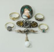 A collection of four gold rings, three-stone set, together with a 9 carat gold bar brooch,