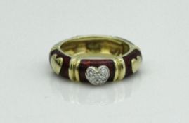 An 18 carat gold enamel and diamond set dress ring with love heart decoration, size M,