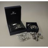 A collection of Swarovski jewellery and charms to include various pins including bee, bear,