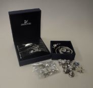 A collection of Swarovski jewellery and charms to include various pins including bee, bear,