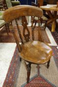 A set of six beech and elm stick back kitchen chairs with circular seats
