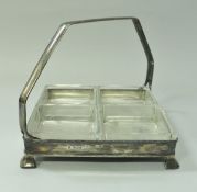 A George V silver hors d'oeuvre stand of simple square form with 4 glass liners raised on four feet