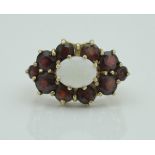 A late 20th Century 9 carat gold opal and garnet set cluster ring in the Victorian taste, size Q/R,