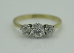 A 9 carat gold three stone diamond set ring, approx 1 carat total,