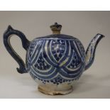 A blue and white glazed terracotta bullet shaped teapot