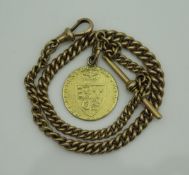 A 9 carat gold watch chain with fob and a George III spade guinea with later suspension hook (date